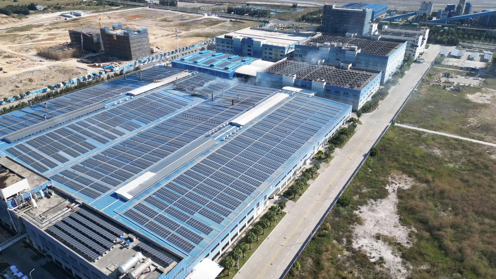Aerial view of solar panels covering the roofs of industrial buildings